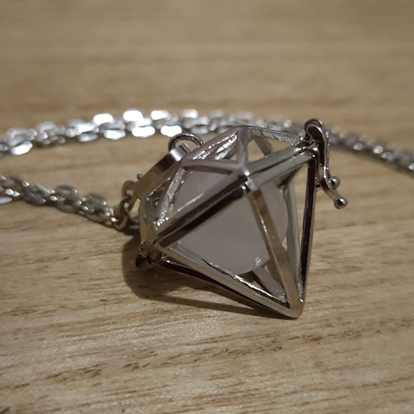 Diamond Shaped Cage Necklace with Rose Quartz Sphere.