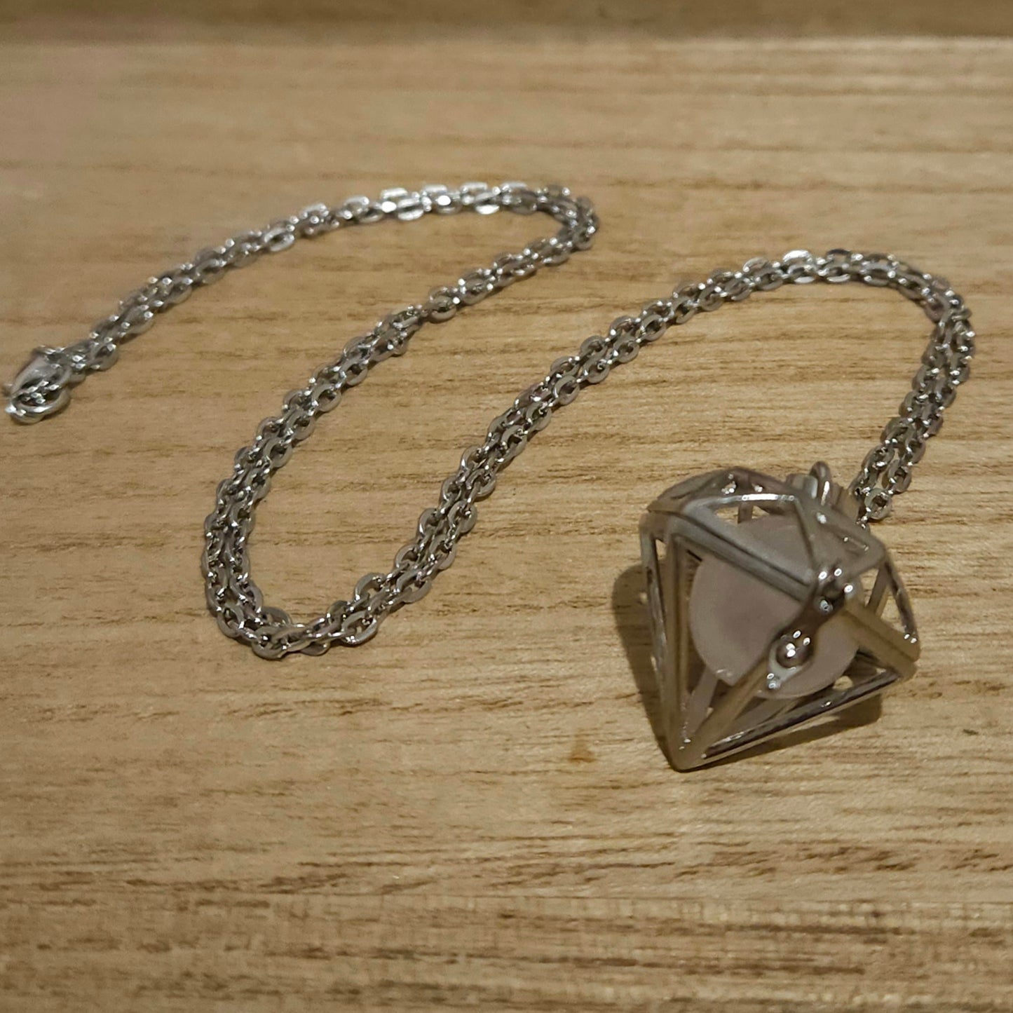 Diamond Shaped Cage Necklace with Rose Quartz Sphere.