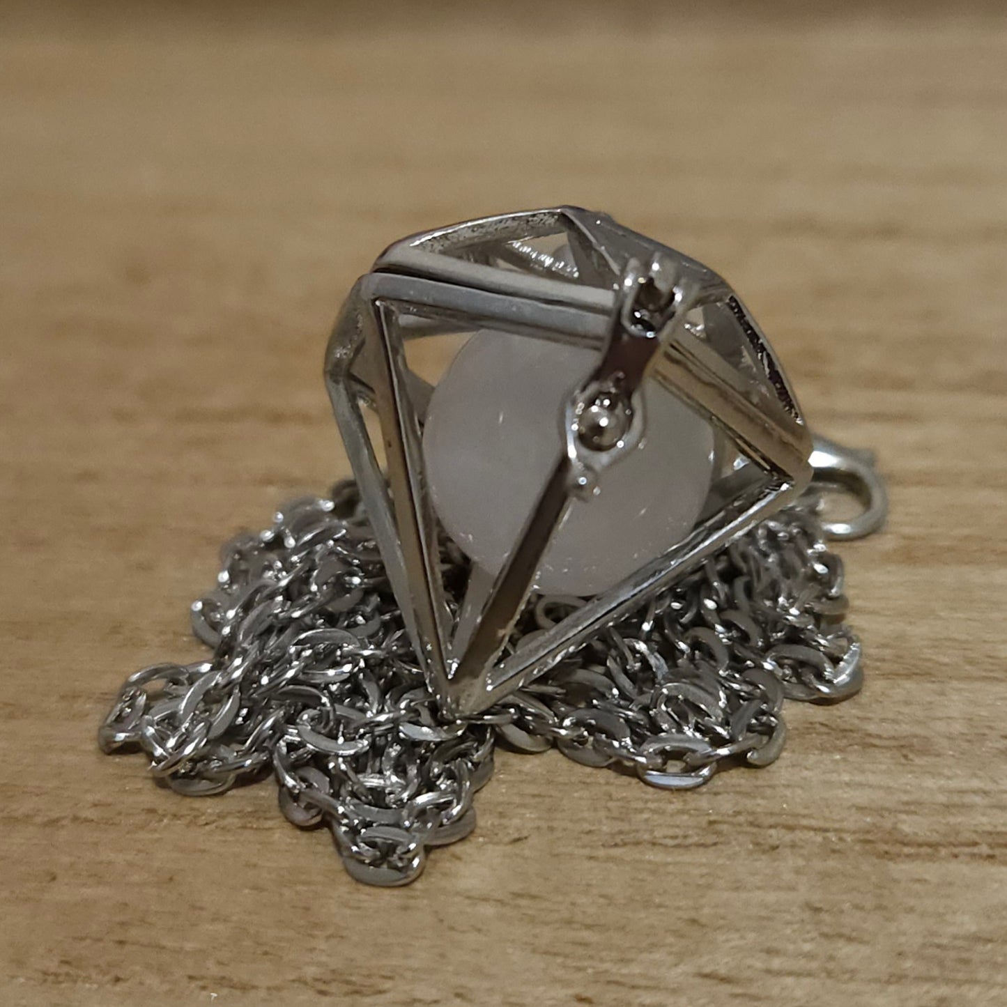 Diamond Shaped Cage Necklace with Rose Quartz Sphere.