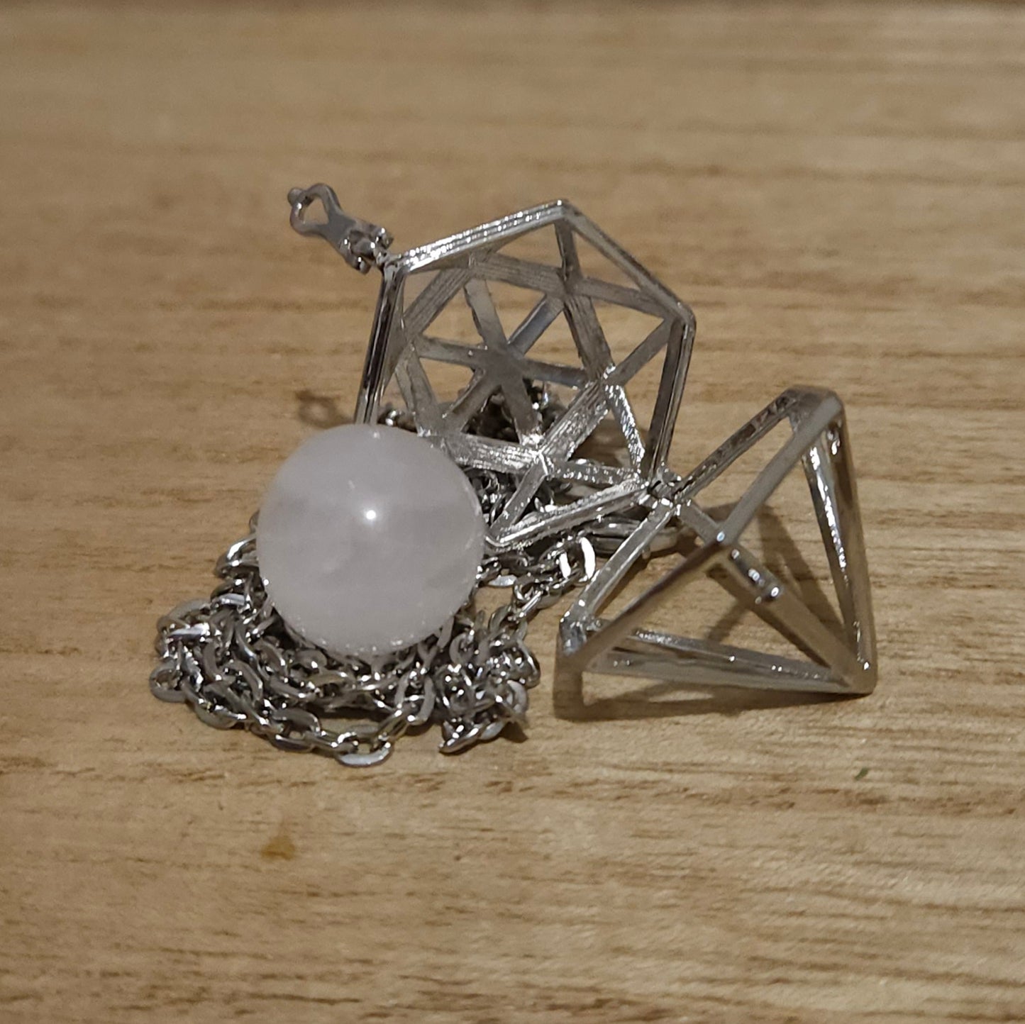 Diamond Shaped Cage Necklace with Rose Quartz Sphere.