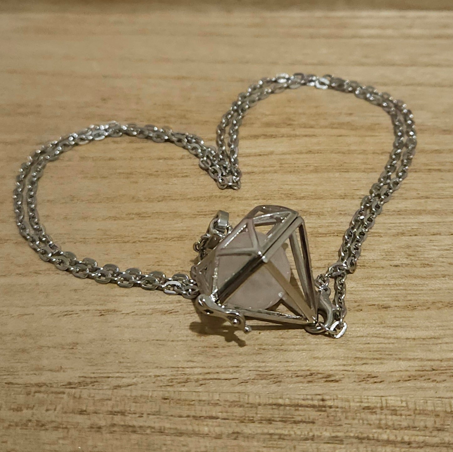 Diamond Shaped Cage Necklace with Rose Quartz Sphere.
