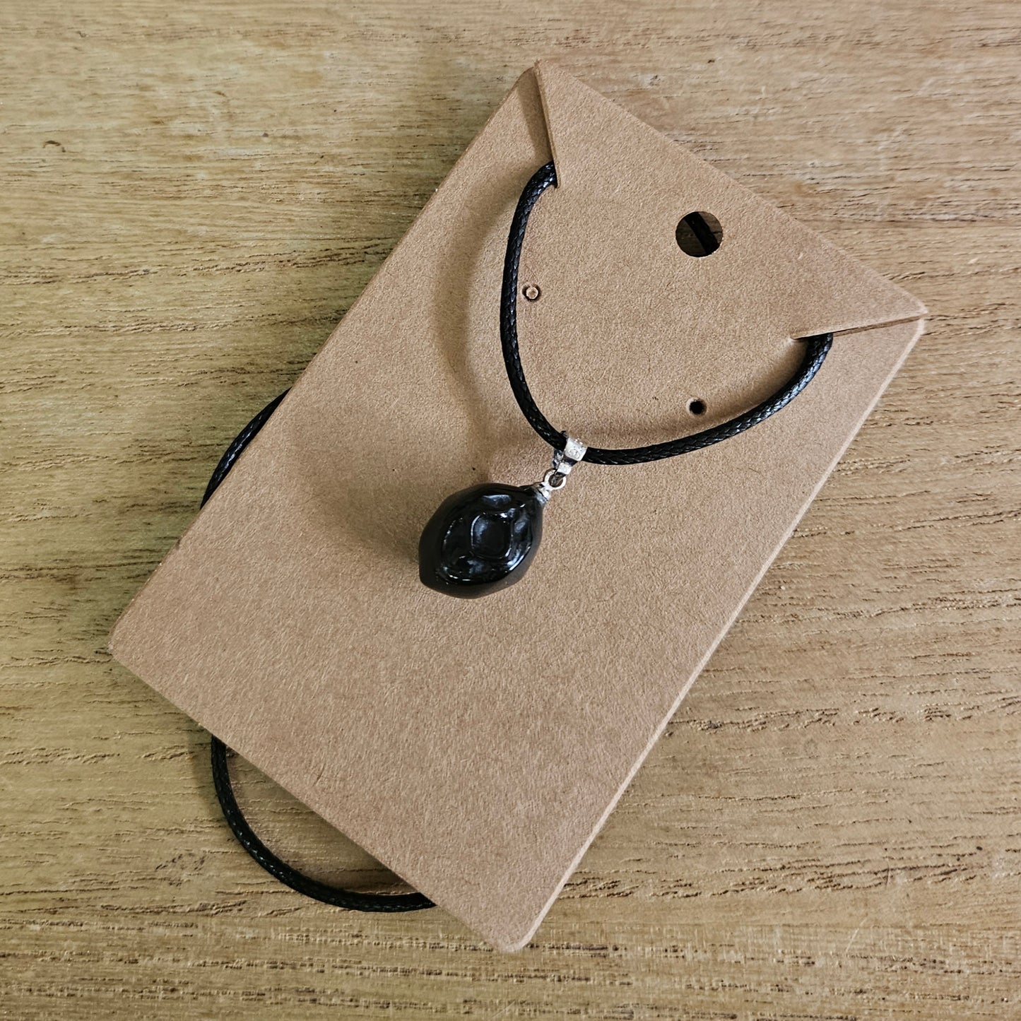 Obsidian Vagina Necklace.